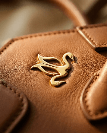 Stud closure on the tan leather paddle pocket